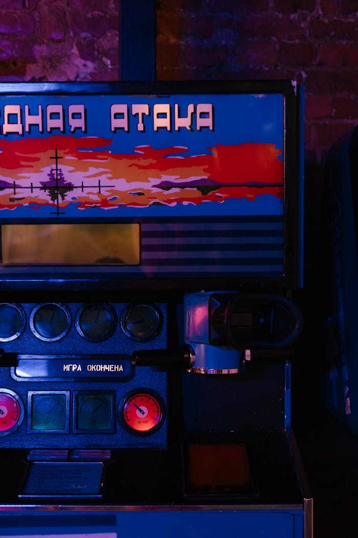 Close-up of vintage arcade machine lit by neon lights, featuring Cyrillic lettering.