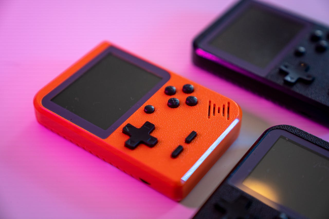 Services Vibrant and nostalgic handheld gaming console in focus, showcasing retro design with a pop of color.